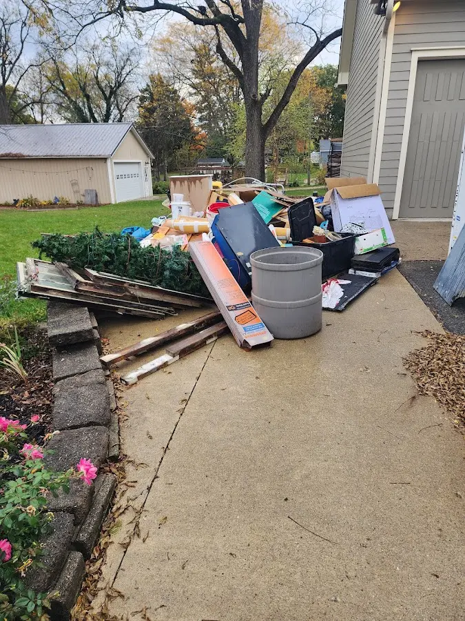 Dumpster being loaded with debris for Estate Cleanout Dumpster Rental in Greenwood